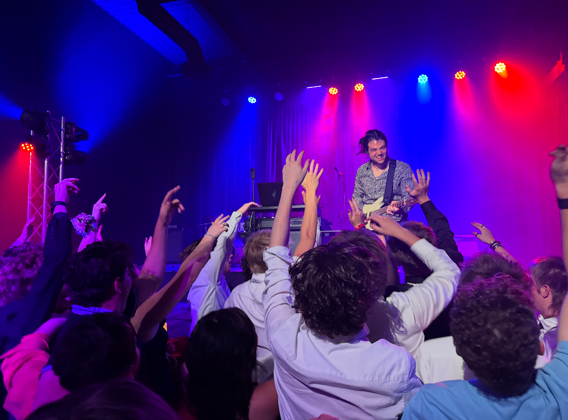 DJ Sauci performing for a packed dance floor